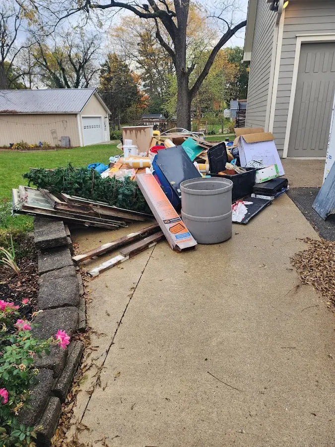 Dumpster being loaded with debris for 12 Yard Dumpster Rental in Columbine